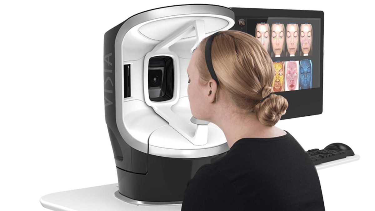 Lady having Visia facial face scanning done. Using expertise and experience to analyze skin